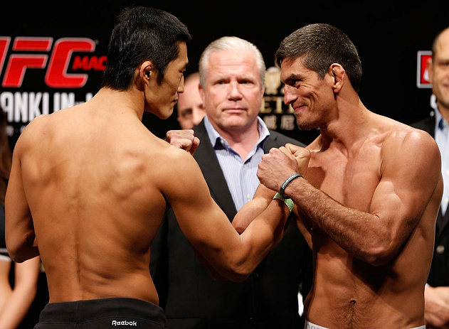 MACAU, MACAU - NOVEMBER 09:  (L-R) Opponents Dong Hyun Kim and Paulo Thiago face off during the UFC Macau weigh in at Cotai Arena on November 9, 2012 in Macau, Macau.  (Photo by Josh Hedges/Zuffa LLC/Zuffa LLC via Getty Images)