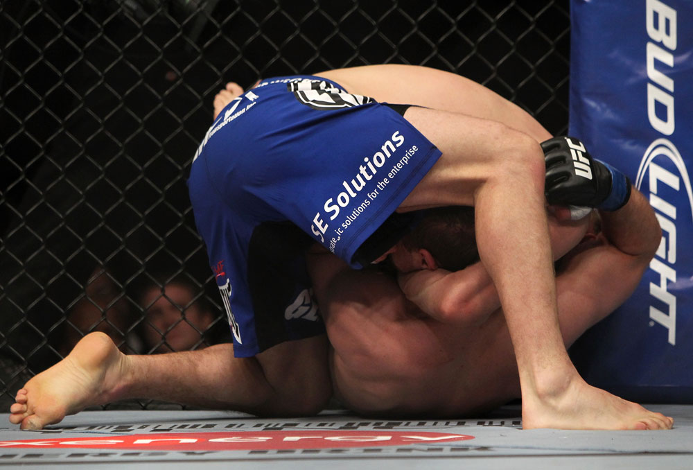 CHICAGO, IL - JANUARY 28:  Evan Dunham (blue shorts) attempts a guillotine choke submission against Nik Lentz during the UFC on FOX event at United Center on January 28, 2012 in Chicago, Illinois.  (Photo by Josh Hedges/Zuffa LLC/Zuffa LLC via Getty Images) *** Local Caption *** Evan Dunham; Nik Lentz