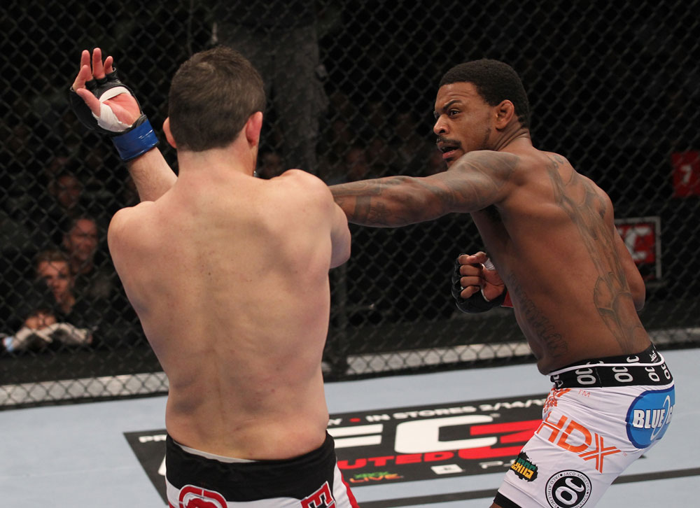CHICAGO, IL - JANUARY 28:  (R-L) Michael Johnson punches Shane Roller during the UFC on FOX event at United Center on January 28, 2012 in Chicago, Illinois.  (Photo by Nick Laham/Zuffa LLC/Zuffa LLC via Getty Images) *** Local Caption *** Michael Johnson; Shane Roller