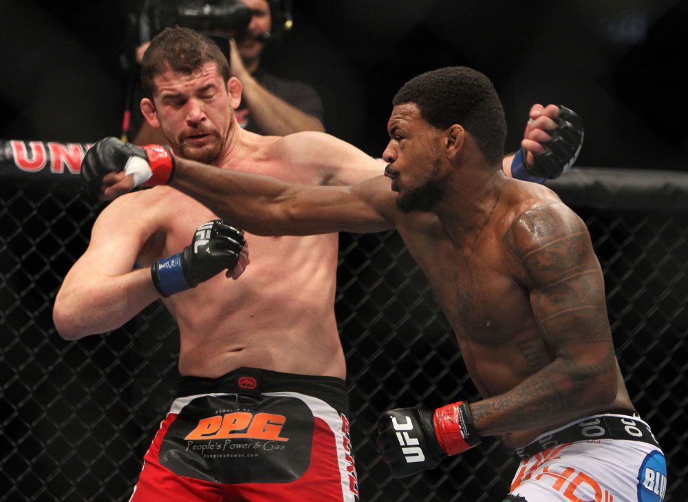 CHICAGO, IL - JANUARY 28:  (R-L) Michael Johnson and Shane Roller trade punches during the UFC on FOX event at United Center on January 28, 2012 in Chicago, Illinois.  (Photo by Josh Hedges/Zuffa LLC/Zuffa LLC via Getty Images) *** Local Caption *** Michael Johnson; Shane Roller