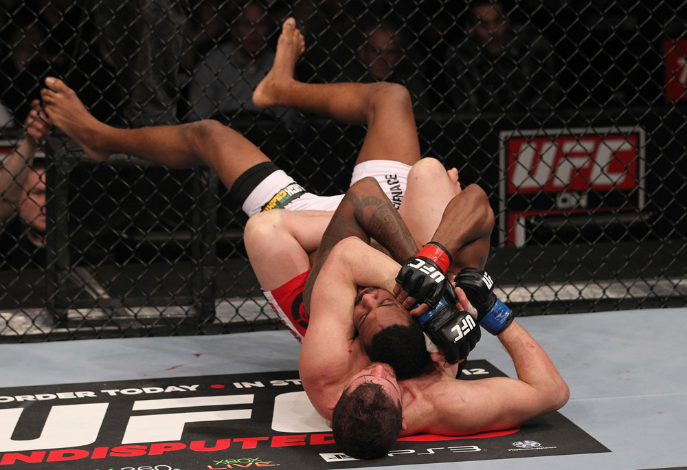 CHICAGO, IL - JANUARY 28:  (L-R) Shane Roller attempts a rear choke submission against Michael Johnson during the UFC on FOX event at United Center on January 28, 2012 in Chicago, Illinois.  (Photo by Nick Laham/Zuffa LLC/Zuffa LLC via Getty Images) *** Local Caption *** Michael Johnson; Shane Roller