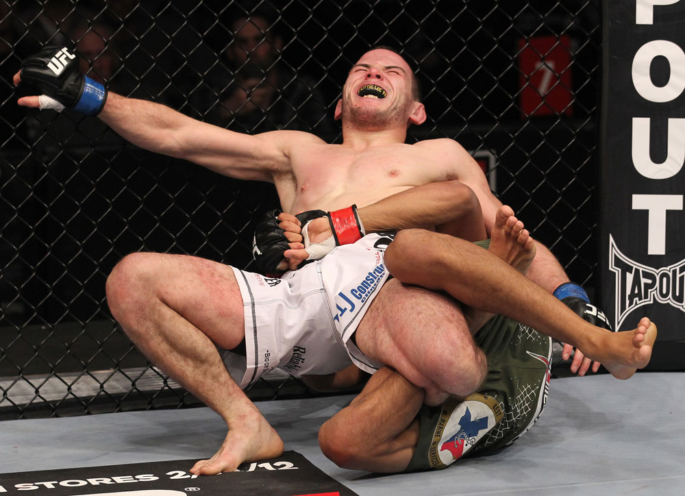 CHICAGO, IL - JANUARY 28:  Eric Wisely grimaces in pain as he is caught in a leg lock submission by Charles Oliveira during the UFC on FOX event at United Center on January 28, 2012 in Chicago, Illinois.  (Photo by Nick Laham/Zuffa LLC/Zuffa LLC via Getty Images) *** Local Caption *** Eric Wisely; Charles Oliveira
