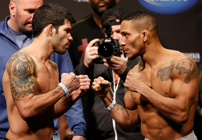 SEATTLE, WA - DECEMBER 07:  (L-R) Opponents Raphael Assuncao and Mike Easton face off during the official UFC on FOX weigh in on December 7, 2012 at Key Arena in Seattle, Washington.  (Photo by Josh Hedges/Zuffa LLC/Zuffa LLC via Getty Images)