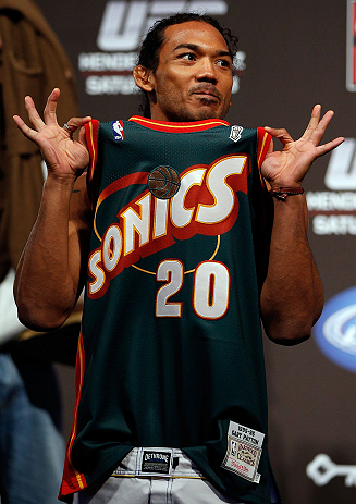 SEATTLE, WA - DECEMBER 07:  Benson Henderson stands on stage wearing a Gary Payton Seattle Sonics jersey during the official UFC on FOX weigh in on December 7, 2012 at Key Arena in Seattle, Washington.  (Photo by Josh Hedges/Zuffa LLC/Zuffa LLC via Getty Images)