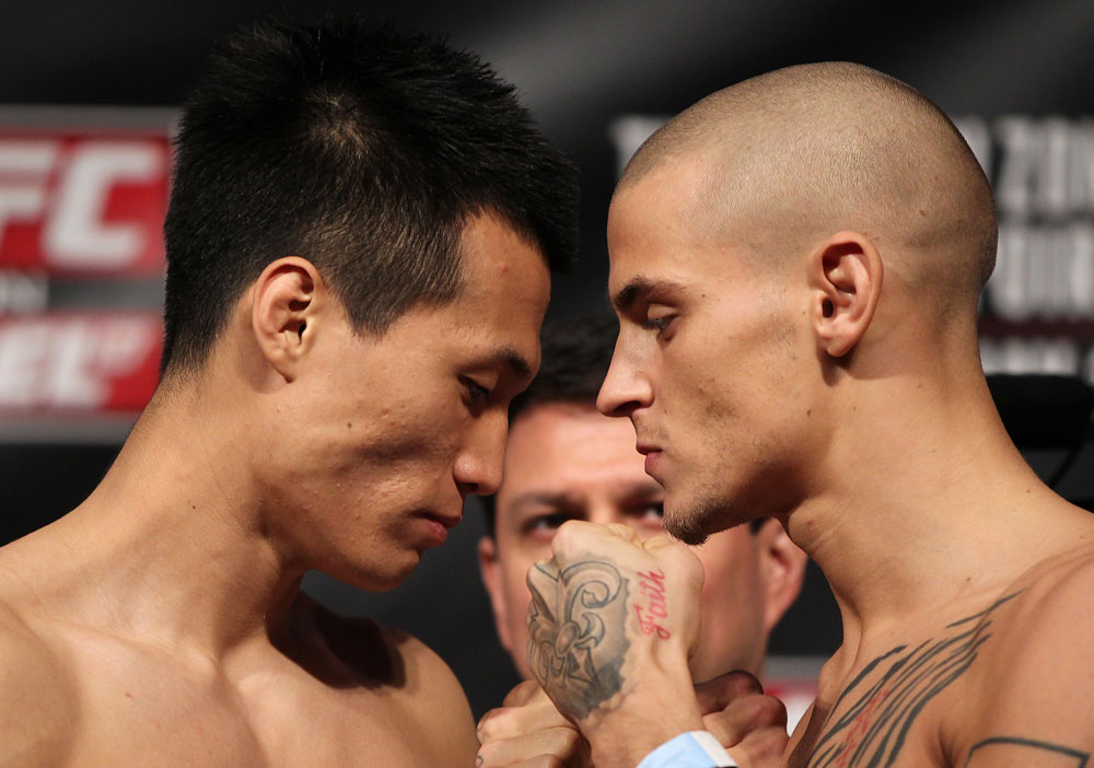 FAIRFAX, VA - MAY 14:  (L-R) Featherweight opponents "The Korean Zombie" Chan Sung Jung and Dustin Poirier face off after weighing in during the UFC on Fuel TV official weigh in at Patriot Center on May 14, 2012 in Fairfax, Virginia.  (Photo by Josh Hedges/Zuffa LLC/Zuffa LLC via Getty Images)