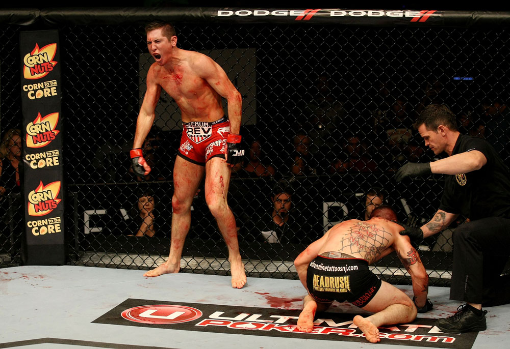 ATLANTIC CITY, NJ - JUNE 22:  Steven Siler (L) celebrates his win by submission guillotine choke as Joe Gambino (C) is tended to by referee Kevin Mulhall (R) in a featherweight bout during UFC on FX 4 at Revel Casino on June 22, 2012 in Atlantic City, New Jersey.  (Photo by Nick Laham/Zuffa LLC/Zuffa LLC)