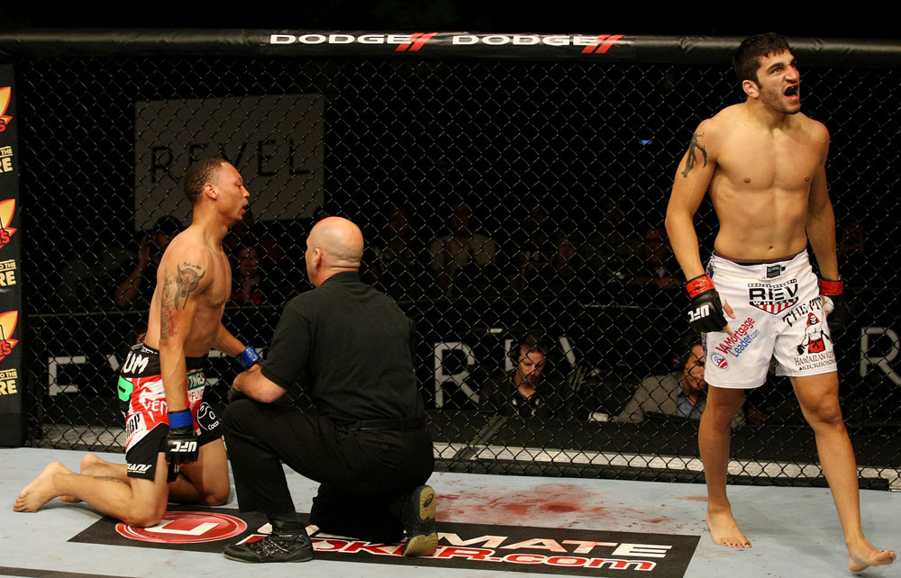 ATLANTIC CITY, NJ - JUNE 22:  Ramsey Nijem (R) celebrates his TKO win over C.J. Keith (L) who is tended to by referee Yves Lavigne (C) in a lightweight bout during UFC on FX 4 at Revel Casino on June 22, 2012 in Atlantic City, New Jersey.  (Photo by Nick Laham/Zuffa LLC/Zuffa LLC)