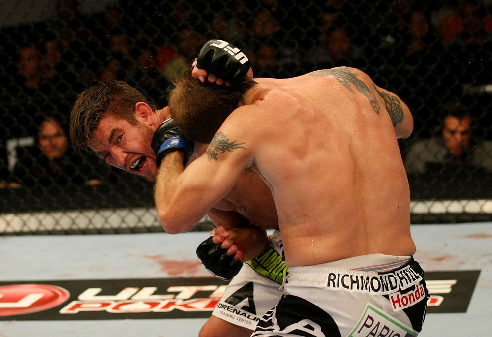 ATLANTIC CITY, NJ - JUNE 22:  Sam Stout (L) punches Spencer Fisher (R) in a lightweight bout during UFC on FX 4 at Revel Casino on June 22, 2012 in Atlantic City, New Jersey.  (Photo by Nick Laham/Zuffa LLC/Zuffa LLC)