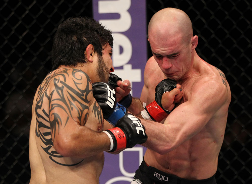 SUNRISE, FL - JUNE 08:   (L-R) Henry Martinez and Bernardo Magalhaes trade punches in Lightweight bout during the UFC on FX 3 event at Bank Atlantic Center on June 8, 2012 in Sunrise, Florida.  (Photo by Josh Hedges/Zuffa LLC/Zuffa LLC via Getty Images)
