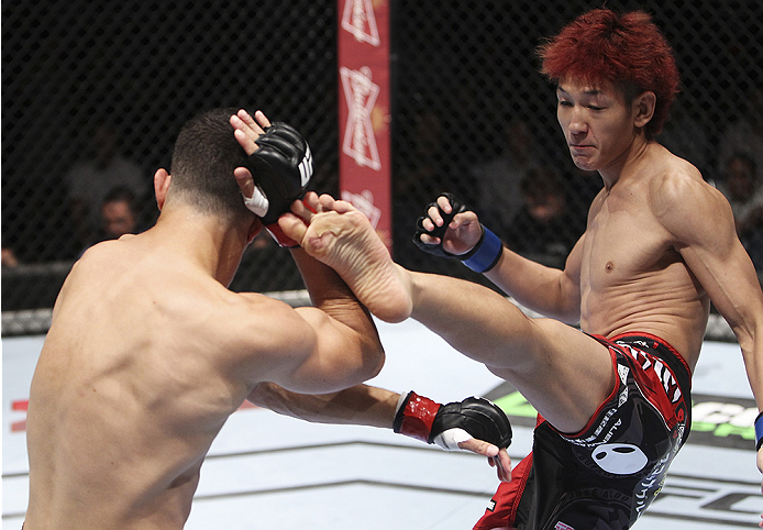 MACAU - AUGUST 23:  Yuta Sasaki kicks Roland Delorme in their bantamweight fight during the UFC Fight Night event at the Venetian Macau on August 23, 2014 in Macau. (Photo by Mitch Viquez/Zuffa LLC/Zuffa LLC via Getty Images)