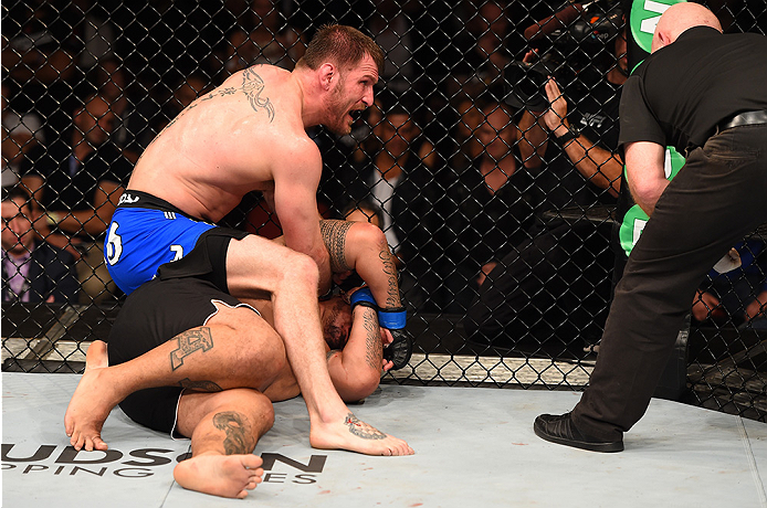 ADELAIDE, AUSTRALIA - MAY 10: Stipe Miocic (top) punches Mark Hunt in their heavyweight bout during the UFC Fight Night event at the Adelaide Entertainment Centre on May 10, 2015 in Adelaide, Australia. (Photo by Josh Hedges/Zuffa LLC/Zuffa LLC via Getty Images)