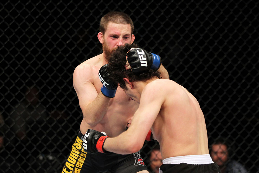 EAST RUTHERFORD, NJ - MAY 05: Nick Denis punches Roland Delorme during thier Bantamweight bout at Izod Center on May 5, 2012 in East Rutherford, New Jersey. (Photo by Josh Hedges/Zuffa LLC/Zuffa LLC via Getty Images)