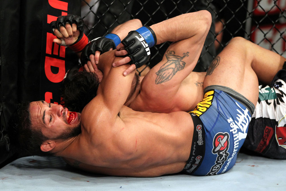 EAST RUTHERFORD, NJ - MAY 05: Dennis Bermudez chokes Pablo Garza during thier Bantamweight bout at Izod Center on May 5, 2012 in East Rutherford, New Jersey. (Photo by Josh Hedges/Zuffa LLC/Zuffa LLC via Getty Images)