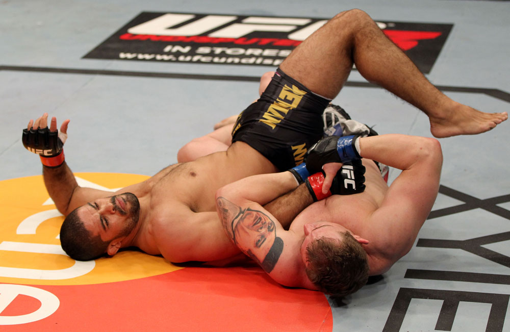 EAST RUTHERFORD, NJ - MAY 05: Alan Belcher (R) wrestles Rousimar Palhares (L) to the ground during thier Middleweight bout at Izod Center on May 5, 2012 in East Rutherford, New Jersey. (Photo by Josh Hedges/Zuffa LLC/Zuffa LLC via Getty Images)