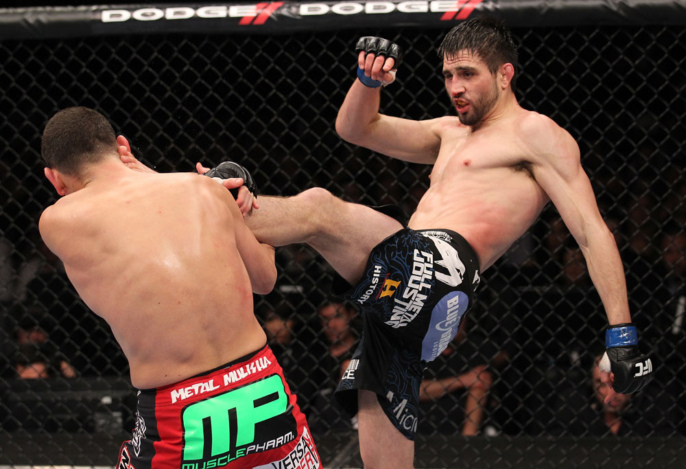 LAS VEGAS - FEBRUARY 04:  (R-L) Carlos Condit kicks Nick Diaz during the UFC 143 event at Mandalay Bay Events Center on February 4, 2012 in Las Vegas, Nevada.  (Photo by Nick Laham/Zuffa LLC/Zuffa LLC via Getty Images) *** Local Caption *** Carlos Condit; Nick Diaz