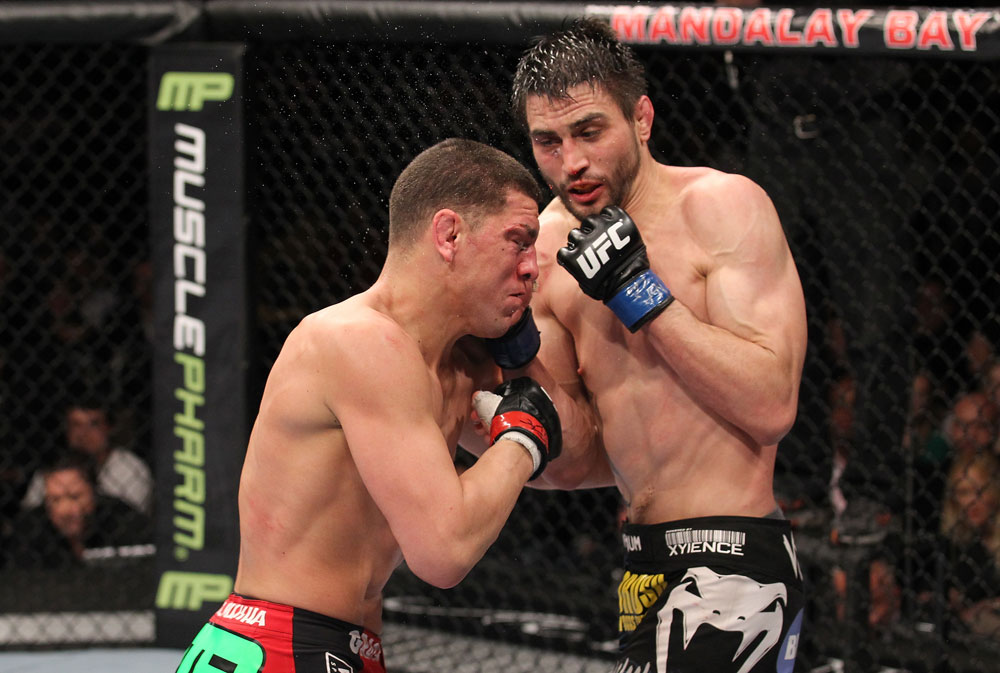 LAS VEGAS - FEBRUARY 04:  Carlos Condit (right) punches Nick Diaz during the UFC 143 event at Mandalay Bay Events Center on February 4, 2012 in Las Vegas, Nevada.  (Photo by Nick Laham/Zuffa LLC/Zuffa LLC via Getty Images) *** Local Caption *** Carlos Condit; Nick Diaz