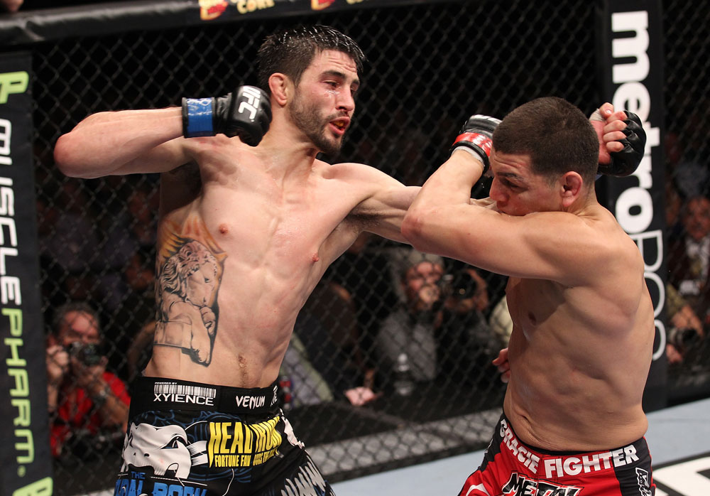 LAS VEGAS - FEBRUARY 04:  Carlos Condit (left) punches Nick Diaz during the UFC 143 event at Mandalay Bay Events Center on February 4, 2012 in Las Vegas, Nevada.  (Photo by Nick Laham/Zuffa LLC/Zuffa LLC via Getty Images) *** Local Caption *** Carlos Condit; Nick Diaz
