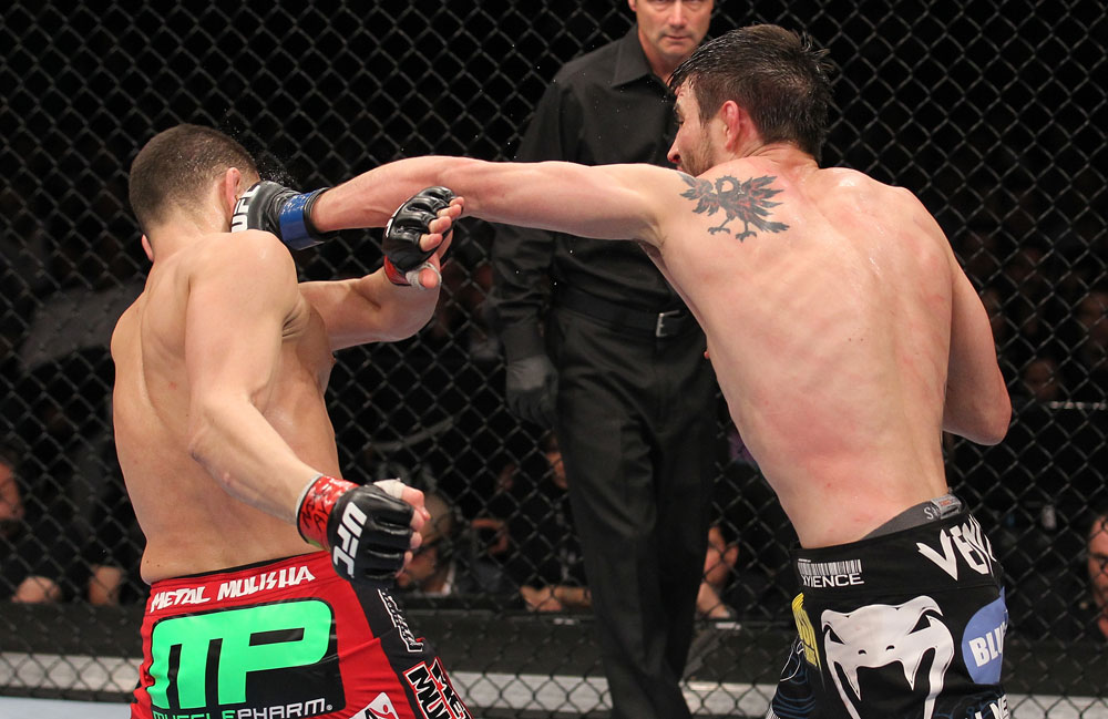 LAS VEGAS - FEBRUARY 04:  Carlos Condit (right) punches Nick Diaz during the UFC 143 event at Mandalay Bay Events Center on February 4, 2012 in Las Vegas, Nevada.  (Photo by Nick Laham/Zuffa LLC/Zuffa LLC via Getty Images) *** Local Caption *** Carlos Condit; Nick Diaz