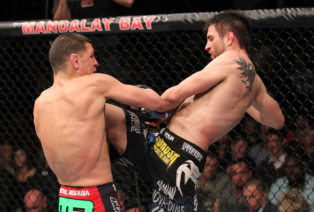 LAS VEGAS - FEBRUARY 04:  Carlos Condit (right) hits Nick Diaz with a knee during the UFC 143 event at Mandalay Bay Events Center on February 4, 2012 in Las Vegas, Nevada.  (Photo by Nick Laham/Zuffa LLC/Zuffa LLC via Getty Images) *** Local Caption *** Nick Diaz; Carlos Condit