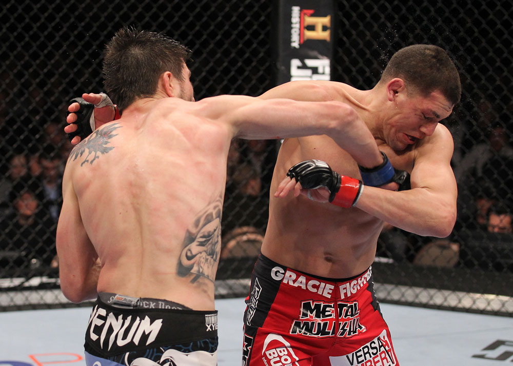 LAS VEGAS - FEBRUARY 04:  Carlos Condit (left) punches Nick Diaz during the UFC 143 event at Mandalay Bay Events Center on February 4, 2012 in Las Vegas, Nevada.  (Photo by Nick Laham/Zuffa LLC/Zuffa LLC via Getty Images) *** Local Caption *** Carlos Condit; Nick Diaz