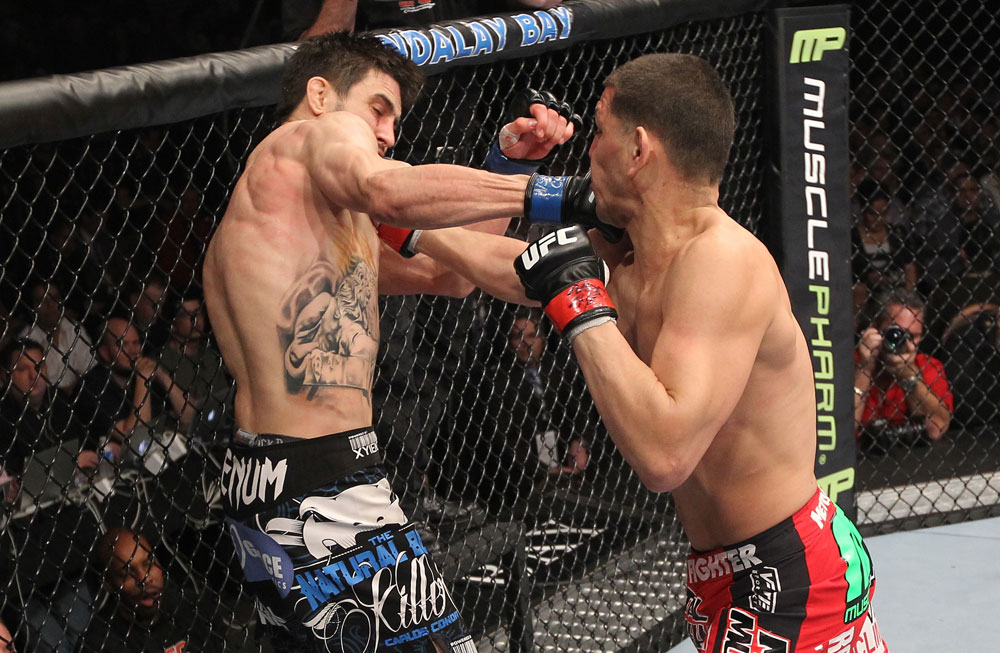LAS VEGAS - FEBRUARY 04:  (R-L) Nick Diaz punches Carlos Condit during the UFC 143 event at Mandalay Bay Events Center on February 4, 2012 in Las Vegas, Nevada.  (Photo by Nick Laham/Zuffa LLC/Zuffa LLC via Getty Images) *** Local Caption *** Carlos Condit; Nick Diaz