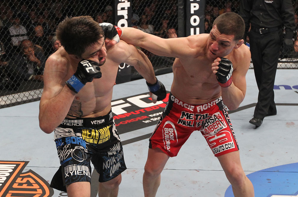 LAS VEGAS - FEBRUARY 04:  (R-L) Nick Diaz punches Carlos Condit during the UFC 143 event at Mandalay Bay Events Center on February 4, 2012 in Las Vegas, Nevada.  (Photo by Nick Laham/Zuffa LLC/Zuffa LLC via Getty Images) *** Local Caption *** Carlos Condit; Nick Diaz
