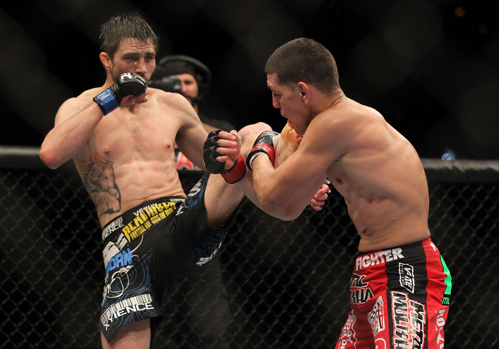 LAS VEGAS - FEBRUARY 04:  Carlos Condit (left) kicks Nick Diaz during the UFC 143 event at Mandalay Bay Events Center on February 4, 2012 in Las Vegas, Nevada.  (Photo by Josh Hedges/Zuffa LLC/Zuffa LLC via Getty Images) *** Local Caption *** Carlos Condit; Nick Diaz