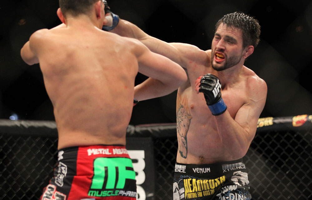 LAS VEGAS - FEBRUARY 04:  Carlos Condit (right) punches Nick Diaz during the UFC 143 event at Mandalay Bay Events Center on February 4, 2012 in Las Vegas, Nevada.  (Photo by Josh Hedges/Zuffa LLC/Zuffa LLC via Getty Images) *** Local Caption *** Carlos Condit; Nick Diaz