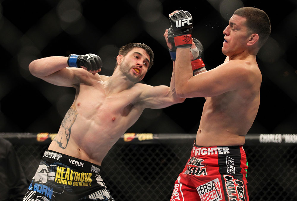 LAS VEGAS - FEBRUARY 04:  Carlos Condit (left) punches Nick Diaz during the UFC 143 event at Mandalay Bay Events Center on February 4, 2012 in Las Vegas, Nevada.  (Photo by Josh Hedges/Zuffa LLC/Zuffa LLC via Getty Images) *** Local Caption *** Carlos Condit; Nick Diaz