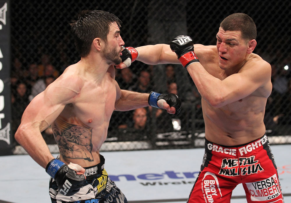 LAS VEGAS - FEBRUARY 04:  (R-L) Nick Diaz punches Carlos Condit during the UFC 143 event at Mandalay Bay Events Center on February 4, 2012 in Las Vegas, Nevada.  (Photo by Nick Laham/Zuffa LLC/Zuffa LLC via Getty Images) *** Local Caption *** Carlos Condit; Nick Diaz