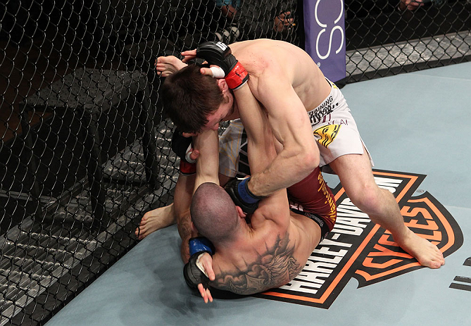 LAS VEGAS, NV - DECEMBER 15: Timothy Elliott (top) punches Jared Papazian (bottom) during their flyweight fight at the TUF 16 Finale on December 15, 2012 at the Joint at the Hard Rock in Las Vegas, Nevada. (Photo by Jim Kemper/Zuffa LLC/Zuffa LLC via Getty Images) *** Local Caption ***Jared Papazian; Timothy Elliott