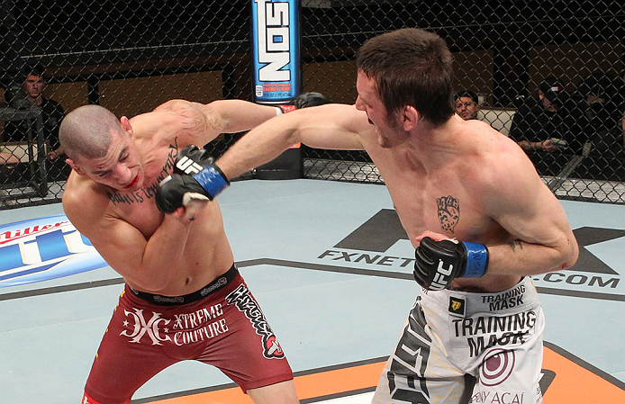 LAS VEGAS, NV - DECEMBER 15: (R-L) Timothy Elliott punches Jared Papazian during their flyweight fight at the TUF 16 Finale on December 15, 2012 at the Joint at the Hard Rock in Las Vegas, Nevada. (Photo by Jim Kemper/Zuffa LLC/Zuffa LLC via Getty Images) *** Local Caption ***Jared Papazian; Timothy Elliott