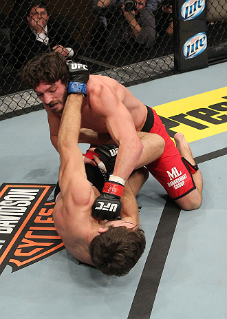 LAS VEGAS, NV - DECEMBER 15: Mike Rio (top) punches John Cofer (bottom) during their lightweight fight at the TUF 16 Finale on December 15, 2012 at the Joint at the Hard Rock in Las Vegas, Nevada. (Photo by Jim Kemper/Zuffa LLC/Zuffa LLC via Getty Images) *** Local Caption *** Mike Rio; John Cofer