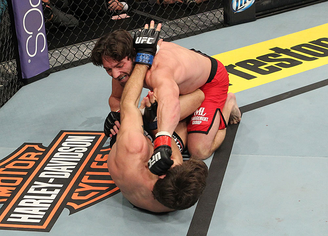 LAS VEGAS, NV - DECEMBER 15: Mike Rio (top) punches John Cofer (bottom) during their lightweight fight at the TUF 16 Finale on December 15, 2012 at the Joint at the Hard Rock in Las Vegas, Nevada. (Photo by Jim Kemper/Zuffa LLC/Zuffa LLC via Getty Images) *** Local Caption *** Mike Rio; John Cofer