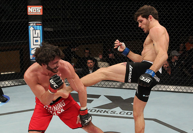 LAS VEGAS, NV - DECEMBER 15: (R-L) John Cofer kicks Mike Rio during their lightweight fight at the TUF 16 Finale on December 15, 2012 at the Joint at the Hard Rock in Las Vegas, Nevada. (Photo by Jim Kemper/Zuffa LLC/Zuffa LLC via Getty Images) *** Local Caption *** Mike Rio; John Cofer