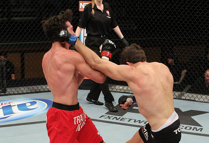 LAS VEGAS, NV - DECEMBER 15: (R-L) John Cofer punches Mike Rio during their lightweight fight at the TUF 16 Finale on December 15, 2012 at the Joint at the Hard Rock in Las Vegas, Nevada. (Photo by Jim Kemper/Zuffa LLC/Zuffa LLC via Getty Images) *** Local Caption *** Mike Rio; John Cofer