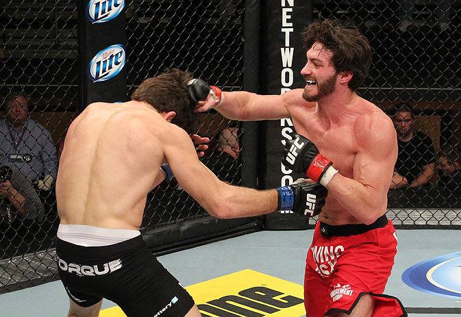 LAS VEGAS, NV - DECEMBER 15: (R-L) Mike Rio punches John Cofer during their lightweight fight at the TUF 16 Finale on December 15, 2012 at the Joint at the Hard Rock in Las Vegas, Nevada. (Photo by Jim Kemper/Zuffa LLC/Zuffa LLC via Getty Images) *** Local Caption *** Mike Rio; John Cofer