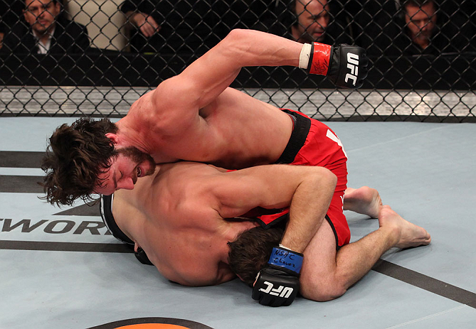 LAS VEGAS, NV - DECEMBER 15: Mike Rio (top) punches John Cofer during their lightweight fight at the TUF 16 Finale on December 15, 2012 at the Joint at the Hard Rock in Las Vegas, Nevada. (Photo by Jim Kemper/Zuffa LLC/Zuffa LLC via Getty Images) *** Local Caption *** Mike Rio; John Cofer