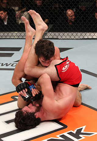 LAS VEGAS, NV - DECEMBER 15: Mike Rio (red shorts) attempts to submit John Cofer during their lightweight fight at the TUF 16 Finale on December 15, 2012 at the Joint at the Hard Rock in Las Vegas, Nevada. (Photo by Jim Kemper/Zuffa LLC/Zuffa LLC via Getty Images) *** Local Caption *** Mike Rio; John Cofer