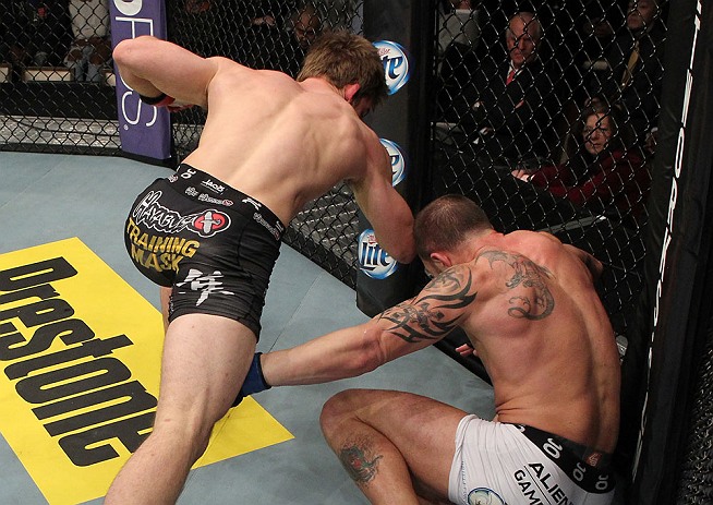 LAS VEGAS, NV - DECEMBER 15: (L-R) T.J. Waldburger punches Nick Catone during their welterweight fight at the TUF 16 Finale on December 15, 2012 at the Joint at the Hard Rock in Las Vegas, Nevada. (Photo by Jim Kemper/Zuffa LLC/Zuffa LLC via Getty Images) *** Local Caption *** T.J. Waldburger; Nick Catone