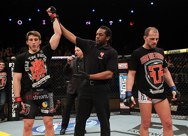 LAS VEGAS, NV - DECEMBER 15: T.J. Waldburger (left) is announced the winner over Nick Catone (right) by referee Herb Dean after their welterweight fight at the TUF 16 Finale on December 15, 2012 at the Joint at the Hard Rock in Las Vegas, Nevada. (Photo by Jim Kemper/Zuffa LLC/Zuffa LLC via Getty Images) *** Local Caption *** T.J. Waldburger; Nick Catone; Herb Dean