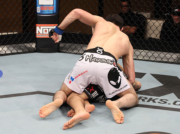 LAS VEGAS, NV - DECEMBER 15: Rustam Khabilov (white shorts) punches Vinc Pichel during their lightweight fight at the TUF 16 Finale on December 15, 2012 at the Joint at the Hard Rock in Las Vegas, Nevada. (Photo by Jim Kemper/Zuffa LLC/Zuffa LLC via Getty Images) *** Local Caption *** Vinc Pichel; Rustam Khabilov