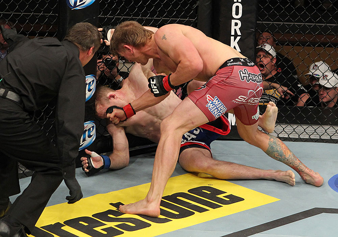 LAS VEGAS, NV - DECEMBER 15: (R-L) Mike Pyle punches James Head as referee Steve Mazzagatti looks on during their welterweight fight at the TUF 16 Finale on December 15, 2012 at the Joint at the Hard Rock in Las Vegas, Nevada. (Photo by Jim Kemper/Zuffa LLC/Zuffa LLC via Getty Images) *** Local Caption *** Mike Pyle; James Head