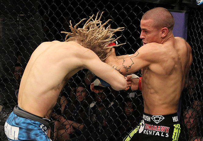 LAS VEGAS, NV - DECEMBER 15: (R-L) Dustin Poirier punches Jonathan Brookins during their featherweight fight at the TUF 16 Finale on December 15, 2012 at the Joint at the Hard Rock in Las Vegas, Nevada. (Photo by Jim Kemper/Zuffa LLC/Zuffa LLC via Getty Images) *** Local Caption *** Dustn Poirier; Jonathan Brookins