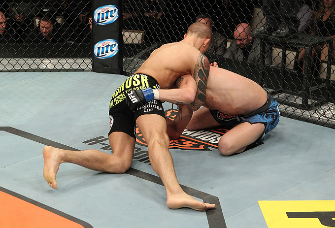 LAS VEGAS, NV - DECEMBER 15: Dustin Poirier (black shorts) attempts to submit Jonathan Brookins during their featherweight fight at the TUF 16 Finale on December 15, 2012 at the Joint at the Hard Rock in Las Vegas, Nevada. (Photo by Jim Kemper/Zuffa LLC/Zuffa LLC via Getty Images) *** Local Caption *** Dustn Poirier; Jonathan Brookins