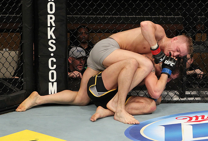 LAS VEGAS, NV - DECEMBER 15: Colton Smith (grey shorts) attempts to submit Mike Ricci during their lightweight fight at the TUF 16 Finale on December 15, 2012 at the Joint at the Hard Rock in Las Vegas, Nevada. (Photo by Jim Kemper/Zuffa LLC/Zuffa LLC via Getty Images) *** Local Caption *** Colton Smith; Mike Ricci
