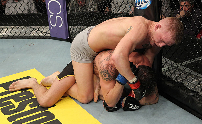 LAS VEGAS, NV - DECEMBER 15: Colton Smith (top) punches Mike Ricci during their lightweight fight at the TUF 16 Finale on December 15, 2012 at the Joint at the Hard Rock in Las Vegas, Nevada. (Photo by Jim Kemper/Zuffa LLC/Zuffa LLC via Getty Images) *** Local Caption *** Colton Smith; Mike Ricci
