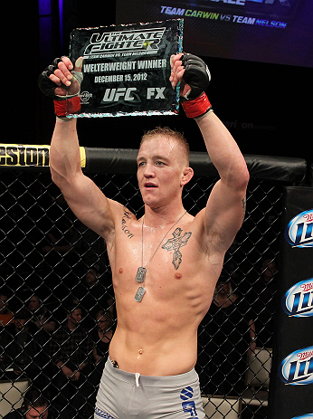 LAS VEGAS, NV - DECEMBER 15: Colton Smith lifts the Ultimate Fighter season 16 trophy after his lightweight fight at the TUF 16 Finale on December 15, 2012 at the Joint at the Hard Rock in Las Vegas, Nevada. (Photo by Jim Kemper/Zuffa LLC/Zuffa LLC via Getty Images) *** Local Caption *** Colton Smith; Mike Ricci