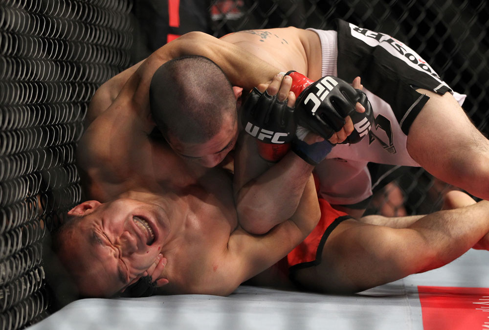 SAITAMA, JAPAN - FEBRUARY 26:  (L-R) Tiequan Zhang struggles to regain position on the ground against Issei Tamura during the UFC 144 event at Saitama Super Arena on February 26, 2012 in Saitama, Japan.  (Photo by Josh Hedges/Zuffa LLC/Zuffa LLC via Getty Images) *** Local Caption *** Tiequan Zhang; Issei Tamura