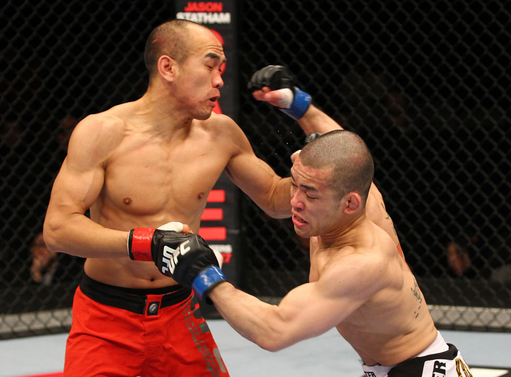 SAITAMA, JAPAN - FEBRUARY 26:  (R-L) Issei Tamura delivers a punch that knocks down Tiequan Zhang during the UFC 144 event at Saitama Super Arena on February 26, 2012 in Saitama, Japan.  (Photo by Al Bello/Zuffa LLC/Zuffa LLC via Getty Images) *** Local Caption *** Tiequan Zhang; Issei Tamura